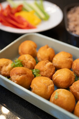 Baked balls of appetizers in baking dish