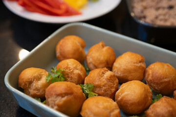 Baked balls of appetizers in baking dish
