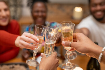 Friends toasting champagne at dinner table 