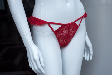 Closeup of red cheeky on mannequin in a fashion store showroom	 - 733917772