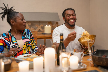 Laughing man plates salad at dinner table 