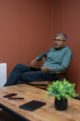 Fototapeta premium Mature businessman sitting in conference room