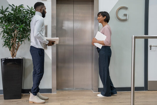 Business people waiting for elevator in office