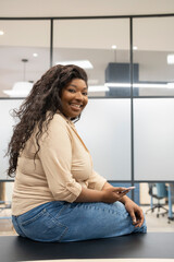 Portrait of smiling businesswoman sitting in board room