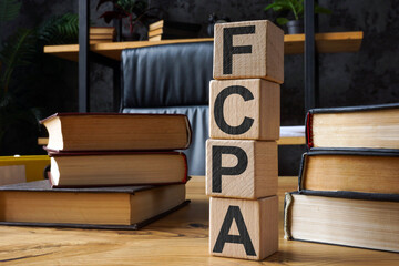 FCPA Foreign Corrupt Practices Act. Wooden cubes with letters on the office table.