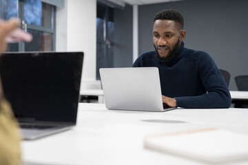 Businessman working on laptop in office