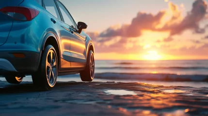 Crédence de cuisine en verre imprimé Coucher de soleil sur la plage Blue compact SUV car open headlamp light parked on concrete road near the mountain at sunset with beautiful sky and clouds. Road trip travel. Automotive industry. Electric and hybrid car technology