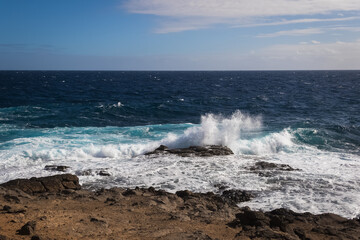 Waves crashing on rocks - 733923100