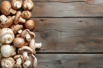 Top view of various kinds of edible mushrooms like champignon, shiitake mushroom, oyster mushroom and crimini mushroom on a rustic wooden table. 