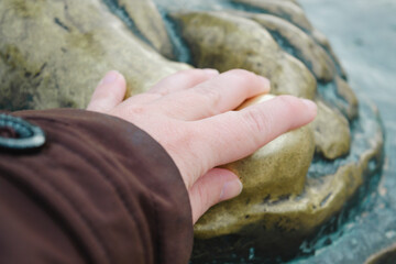 Bishop Grgur statue, belief connected with the bronze statue which says that touching the big toe will fulfill one's wishes, city of Nin, Zadar county, Croatia, 16:12.2023