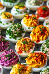 A vibrant display of deviled eggs featuring a variety of toppings and fillings