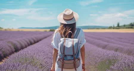 Gardinen Tourist with backpack enjoying sunny day in lavender field © Photocreo Bednarek