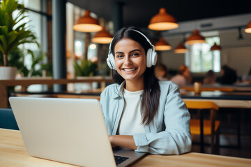Smiling young woman wearing a headphone and working remotely on a laptop. Generative AI 