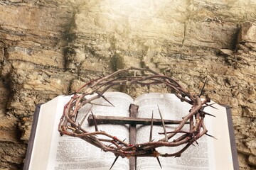 Crown of thorns on holy Bible with flower. Easter concept.