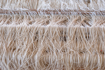 Weave silk cotton on the manual wood loom. Silk clothes from nature material.