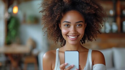 Black woman holding and pointing at blank smartphone screen, millennial African American lady recommending new app or mobile website, mockup image.