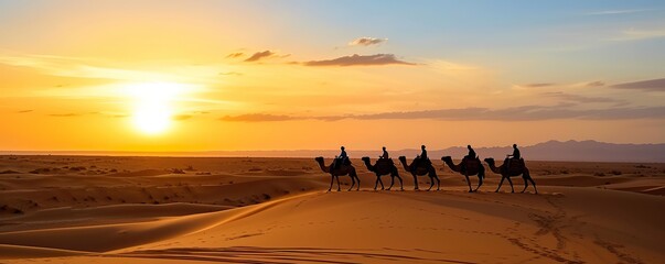 Fototapeta na wymiar Desert landscape at sunset on a sunny afternoon with camels running