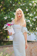 Old Hollywood Glam: Beautiful Woman in Polka Dot Dress by Bushes