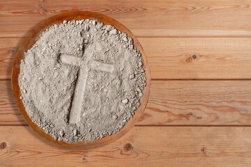 cross on grey ash, dust in plate, christian religion