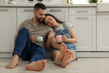 Fototapeta premium Affectionate young couple spending time together in kitchen. Space for text