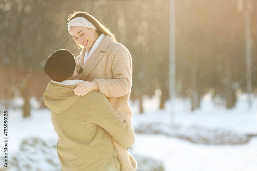 Wall mural beautiful young couple enjoying winter day outdoors