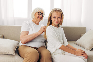 Sofa love happy family comb child grandmother granddaughter couch girl home