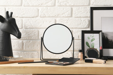 Dressing table with mirror, makeup products and accessories in room