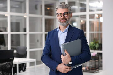 Portrait of smiling man with folder in office, space for text. Lawyer, businessman, accountant or manager