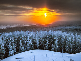 Winter evening landscape with sunset. Snow covering is everywhere and it reflected colors by sunset.