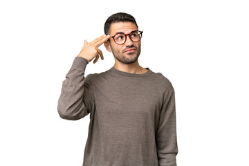 Fototapeta premium Young handsome caucasian man over isolated background with problems making suicide gesture