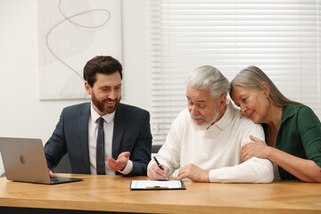 Notary consulting senior couple about Last Will and Testament in office