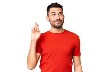 Young handsome caucasian man over isolated chroma key background with fingers crossing and wishing the best