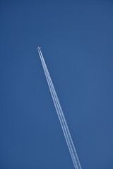 Airplane flies fast to make contrails in the sky