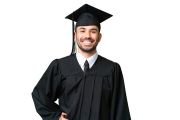 Young university graduate man over isolated chroma key background posing with arms at hip and smiling