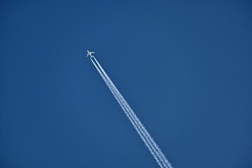 Airplane flies fast to make contrails in the sky