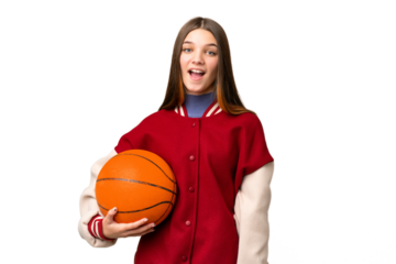 Teenager girl playing basketball over isolated chroma key background with surprise facial expression