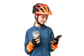 Teenager cyclist girl over isolated chroma key background holding coffee to take away and a mobile