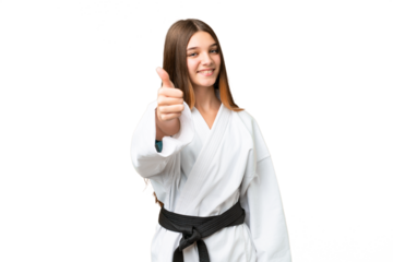 Teenager girl doing karate over isolated chroma key background with thumbs up because something good has happened