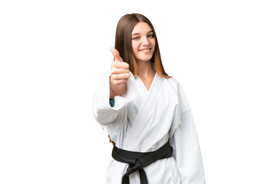 Teenager girl doing karate over isolated chroma key background with thumbs up because something good has happened