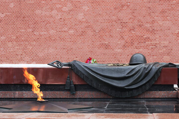 Tomb of Unknown soldier and Eternal flame in Alexander garden near Kremlin wall in Moscow, Russia