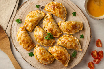 Baking delicious Argentine empanadas with chicken and vegetables.
