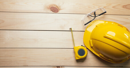 Work safety. Standard Construction site protective equipment on  top view wooden background, flat...