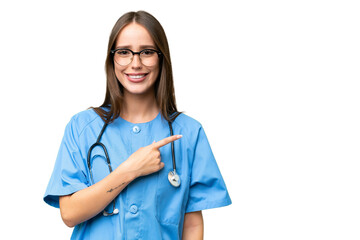 Young nurse caucasian woman over isolated background pointing to the side to present a product