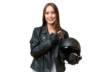 Young pretty caucasian woman with a motorcycle helmet over isolated background pointing to the side...