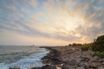 Fototapeta premium Sunset at the beach with a shipwreck in the distance