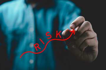 Businessman writing red wording with up arrow for risk analysis and assessment concept.