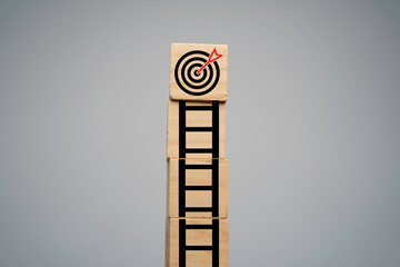 Dartboard with arrow on the top of ladders step for enhance  objective target and promote goal...