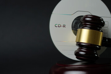 CD compact disc and judge gavel background with copy-space