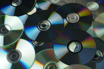 Stacked CD DVD background, close-up.