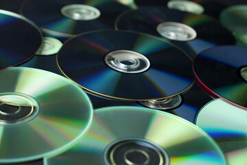 Stacked CD DVD background, close-up.